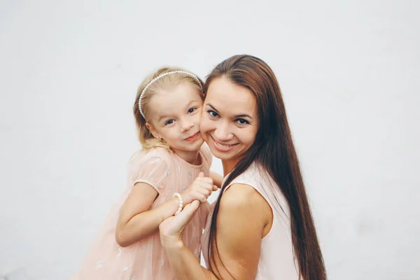 Baby in the arms of the mother. on white background Woman holding a child. Fashion for girl. — Stock Photo, Image