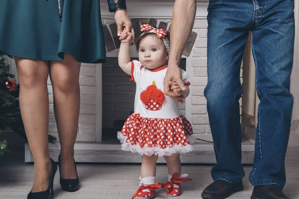 Cute baby learning to walk and make his first steps. mom is holding his hand. child's feet close up, copy space — Stock Photo, Image