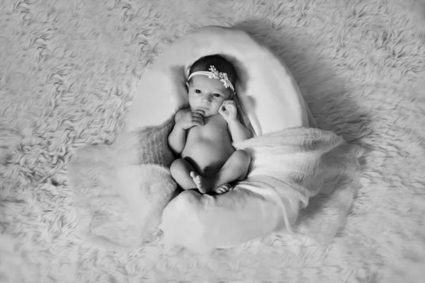 Retrato de una niña pequeña con una flor en el pelo: primer plano de la cara del bebé —  Fotos de Stock