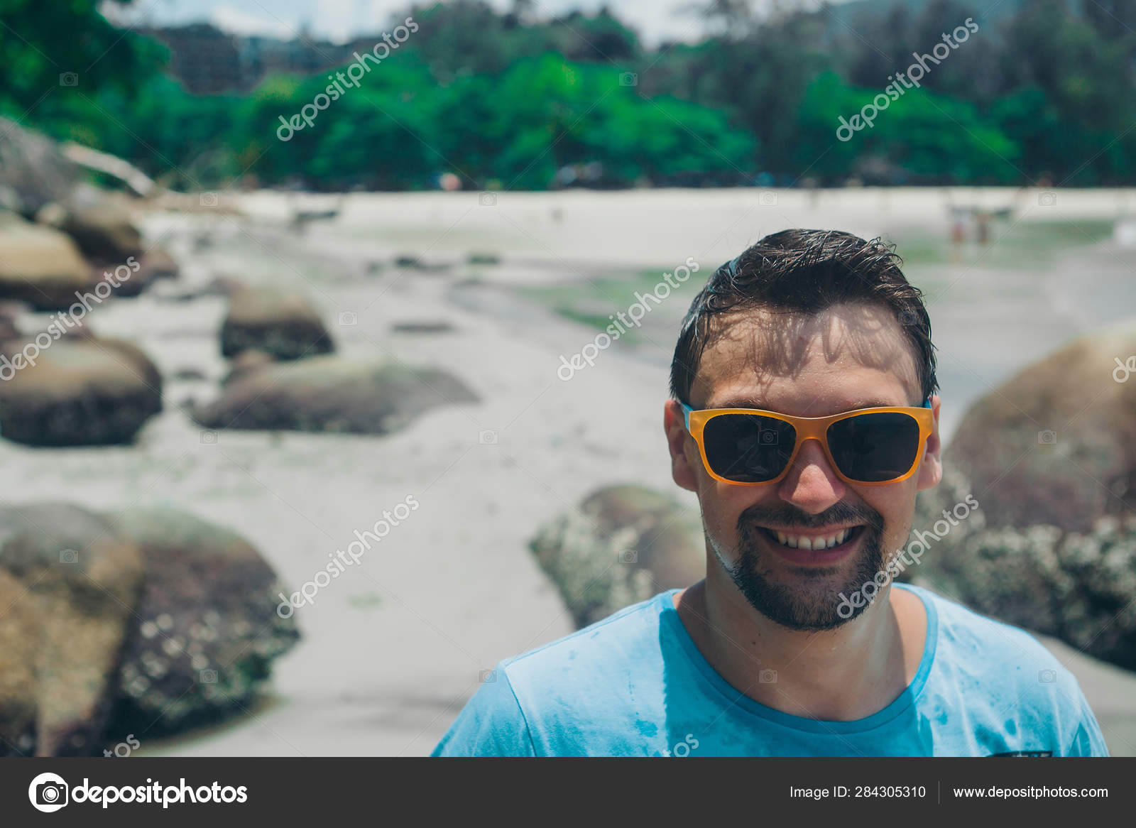 Portrait Of A Tourist With Long Hair In Sunglasses And A White T