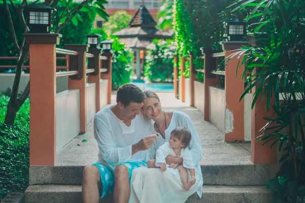 family holiday by the sea: man, woman and child on the beach. concept of travel