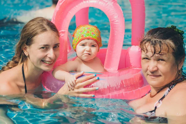 Les femmes enseignent à bébé à nager. Fille avec des jouets gonflables pour la piscine. Le concept d'enseignement de la natation, accessoires, loisirs — Photo