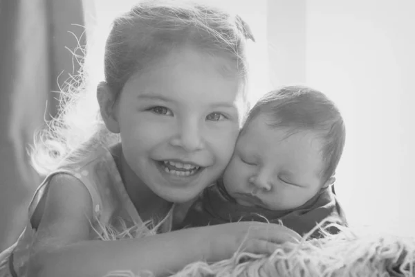 El concepto de un estilo de vida saludable, la protección de los niños, ir de compras - un adolescente con un bebé recién nacido jugando juntos. Niños felices: hermano y hermana sobre fondo blanco —  Fotos de Stock