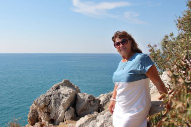 turizm kavramı, rekreasyon-güzel bir kadın deniz bakan otelin balkonunda duran