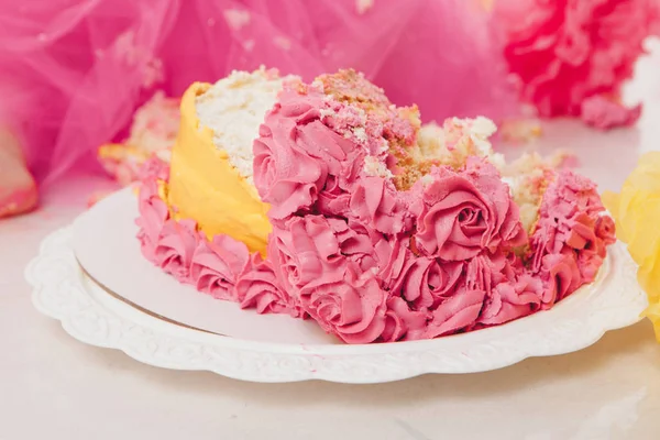Destroyed cake on white background close-up. Confectionery decorated with roses. Baking advertising concept, calorie, nutrition, diet — Stock Photo, Image