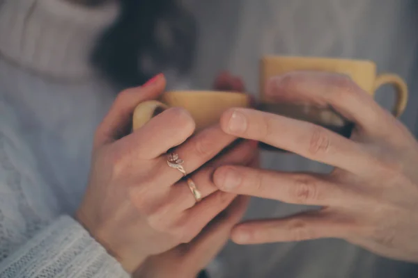 male, female hands and cups close-up. Break for lunch or coffee, tea, couple in love. Valentine\'s day