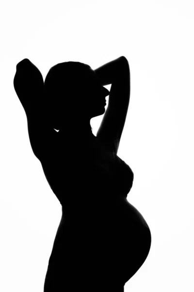 Силуэт беременной женщины на белом фоне. Концепция здорового образа жизни, ЭКО — стоковое фото