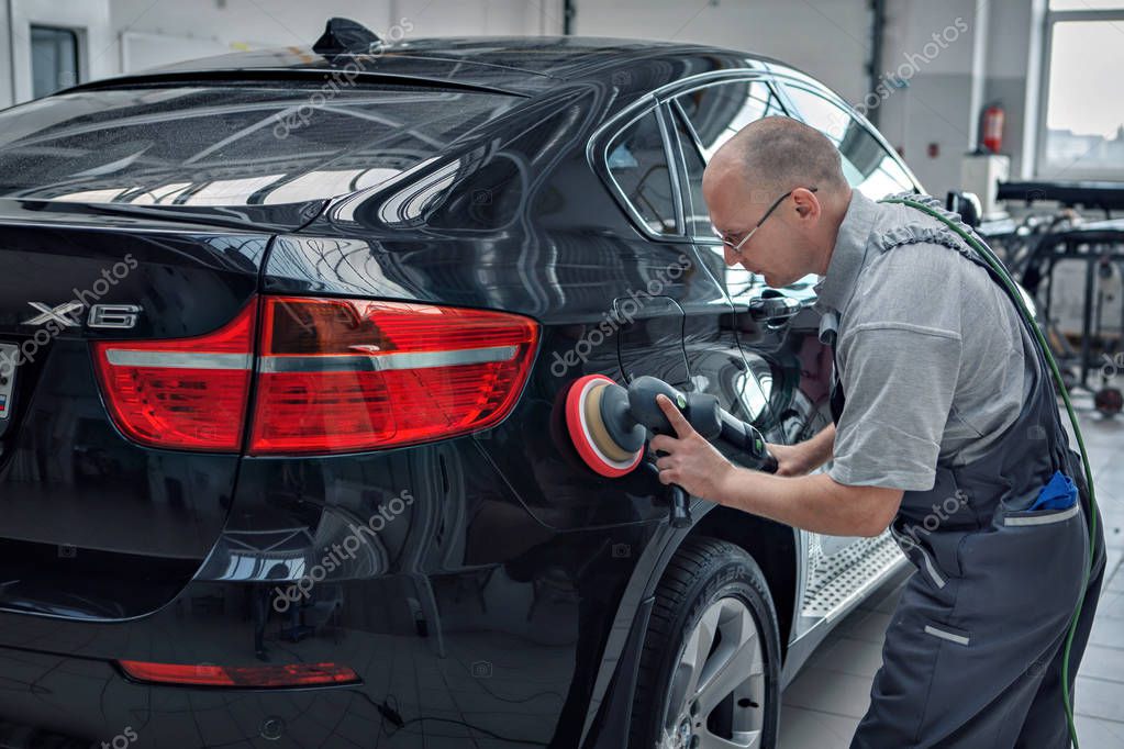 Advertising car wash, Moscow, 1.11.2018: polishing the surface of the car. The icon of the BMW motor company