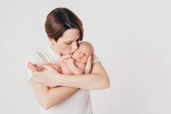 Foto in bianco e nero: la madre tiene il figlio tra le braccia. Ritratto di famiglia: una donna con un bambino. Concetto di assistenza sanitaria: famiglia sana — Foto Stock