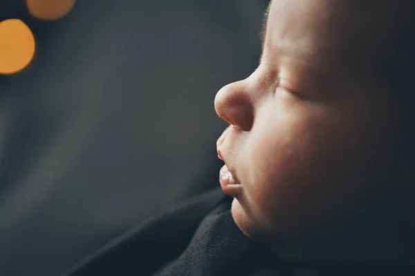 Portrait of a little girl: baby's face close-up on balck background. boce as background concept of childhood, healthcare, IVF, Christmas, new year holidays — Stock Photo, Image