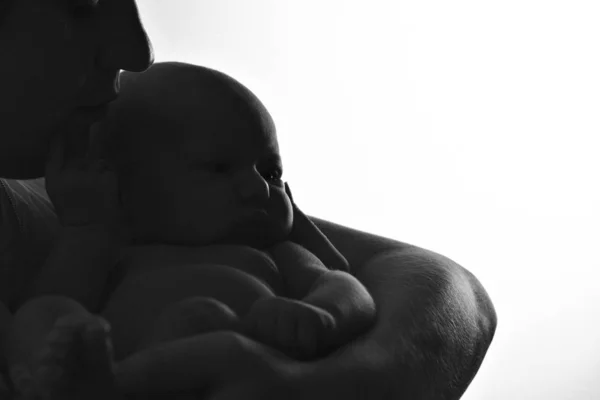 黒と白の写真:母親は息子を腕に抱えています家族の肖像:子供を持つ女性。ヘルスケアの概念:健康的な家族 — ストック写真