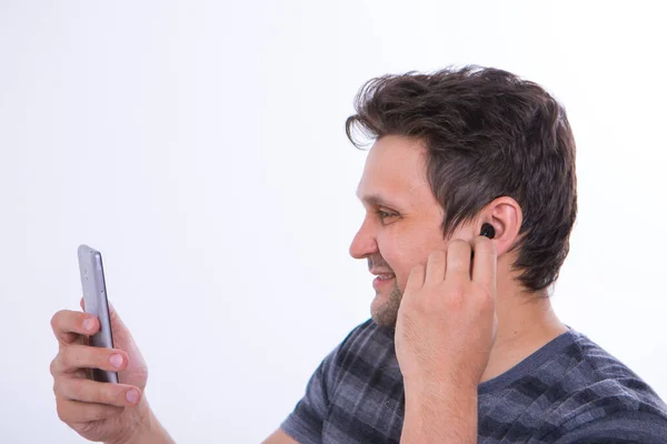 Girl Inserts Wireless Headset Her Ear Starts Talking Phone Using — Stock Photo, Image