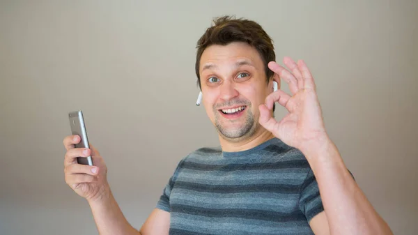 Happy Guy Inserts Wireless Headset His Ear Man Modern Technologies — Stock Photo, Image