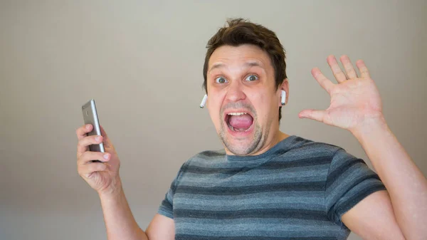 Happy Guy Inserts Wireless Headset His Ear Man Modern Technologies — Stock Photo, Image