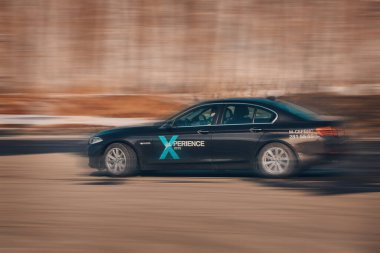 BMW reklamcılık, Moskova, 1.11.2018: Siyah bir arabanın modeli, test pistindeki arabalar, tekerleklerin altından çıkan toz, yoldaki raylar, yarış, sürüş okulunda sürüş eğitimi, şehirde dağıtım, taksi