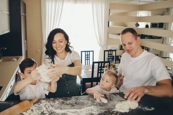 the family makes cakes. the children were covered in flour. dinner at the bakery. feast in the kitchen