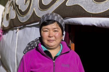Altyn-Arashan, Kyrgyzstan, August 14 2018: A pretty Kyrgyz stands in front of a yurt in the valley of Altyn-Arashan in Kyrgyzstan clipart