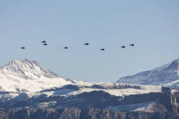 The Swiss Air Force flies with its helicopters a display in the Alps in the Bernese Oberland in Switzerland