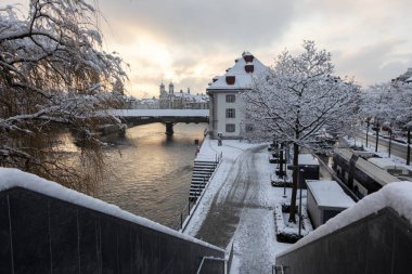 Lucerne, Switzerland, February 4, 2019: Old town of Lucerne with snowy trees on a cold winter morning