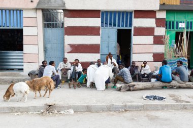 Hamd ela, Etiyopya, Şubat 23 2015: Etiyopyalı erkekler sokakta konuşmak ve eski teneke kutulardan yerel bir içki içme dışarıda oturmak