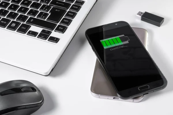 Smartphone being charged by another device via wireless charging