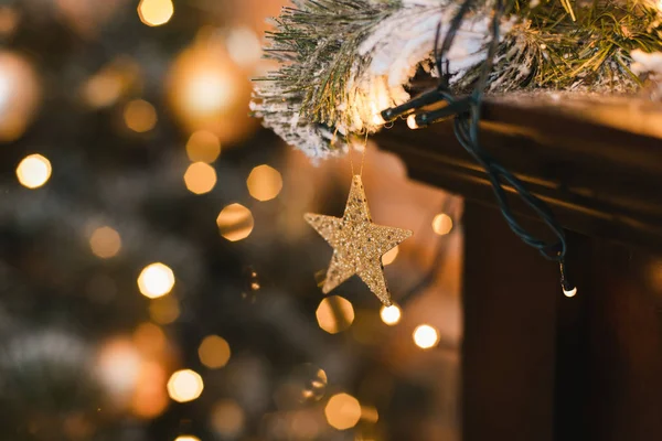 Closeup of Christmas star lights on Christmas tree. Xmas background with christmas decoration.