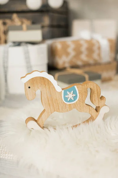 Toy horse with Christmas gifts on  background