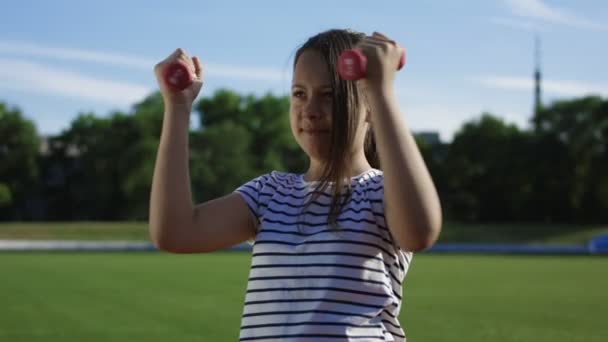 Children training with dumbbells outside — Stock Video