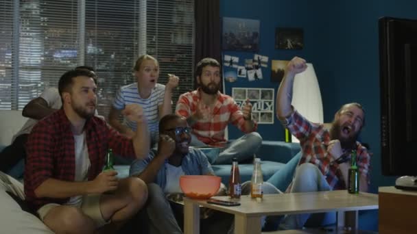 Friends Chilling On Sofa While Watching Game On Tv Stock Video C Evgeniyshkolenko