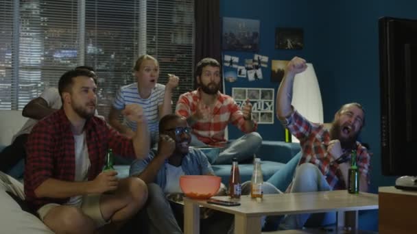 Friends chilling on sofa while watching game on TV — Stock Video