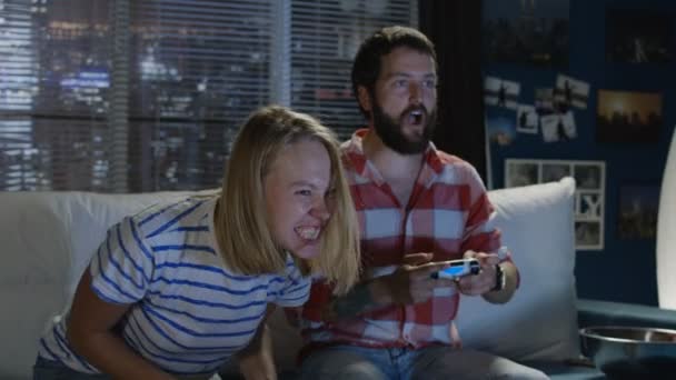 Casal expressivo jogando videogame em casa — Vídeo de Stock