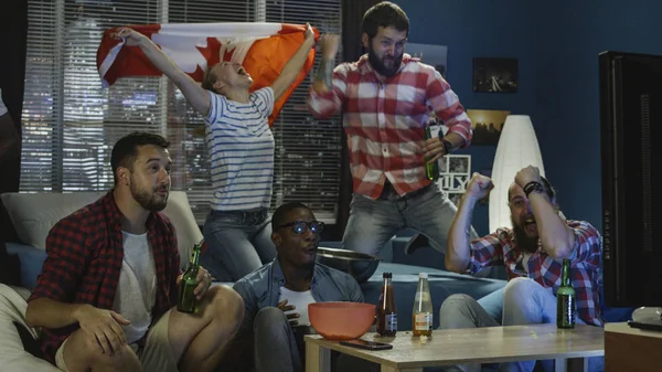 Excited patriotic fans with beer watching game — Stock Photo, Image