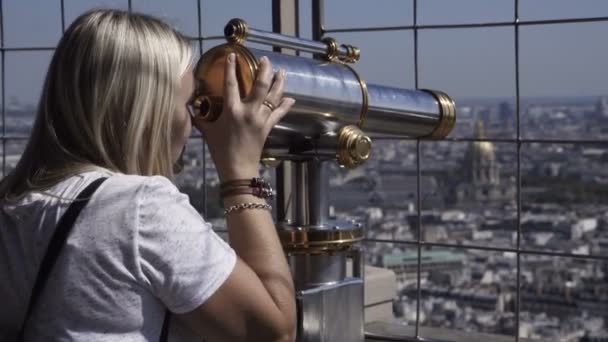 Woman observing city with coin binocular — Stock Video