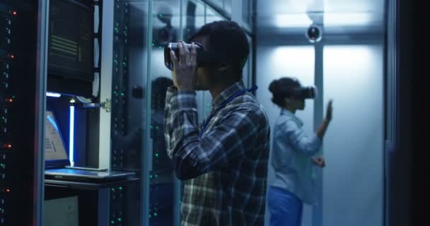 Ethnische IT-Spezialisten mit VR-Brille im Serverraum — Stockvideo