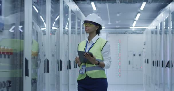 Sonriente mujer negra trabajando en el centro de la planta solar — Vídeo de stock