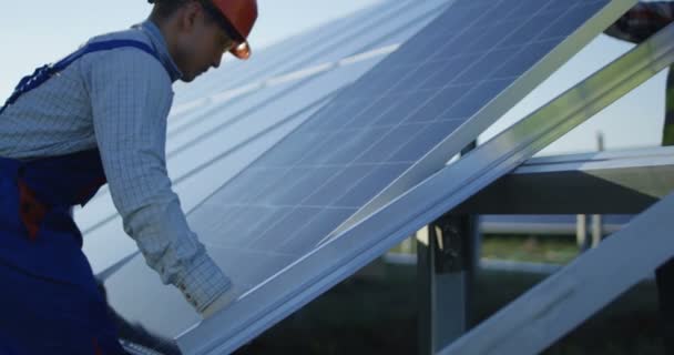 Hombres instalando panel solar al aire libre — Vídeo de stock