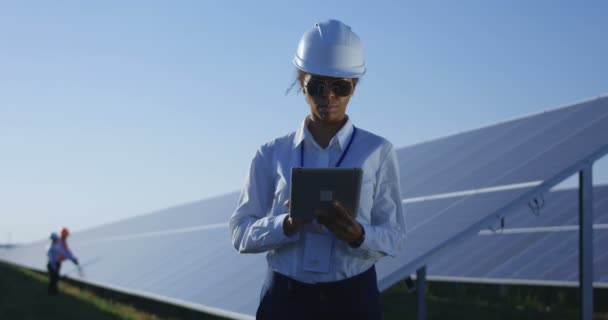 Mujer trabajadora eléctrica en su tableta afuera — Vídeo de stock