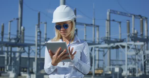 Trabajadora eléctrica sonriente en una tableta — Vídeos de Stock