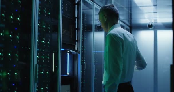 Technicus werkt op een laptop in een datacenter — Stockvideo