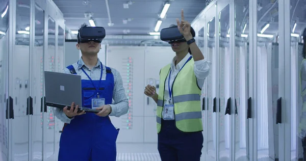 Diversos ingenieros con portátil en el centro de la estación eléctrica — Foto de Stock