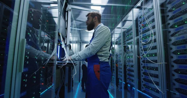 Manager and technician working in a data center