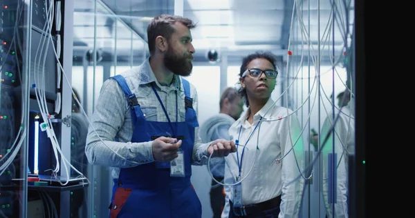 Three people working in a data center