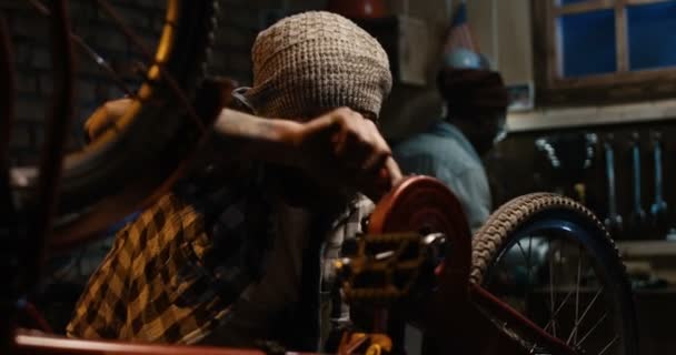 Deux hommes travaillant dans un atelier de réparation de vélos 