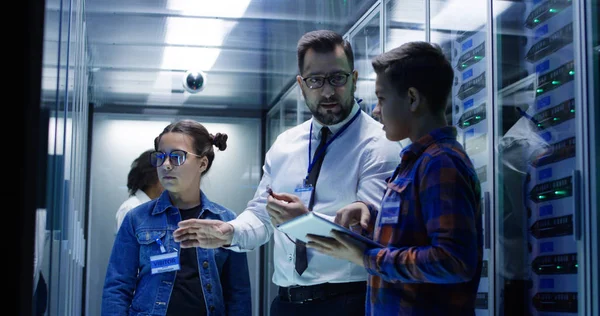 IT technician showing cable to children