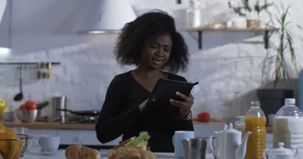 女性は、台所で彼女のタブレットを使用して — ストック動画