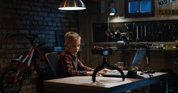 Boy talking on camera in a garage — Stock Photo, Image