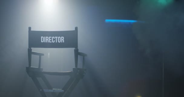 Chair of director with clapboard in spotlight — Stock Video