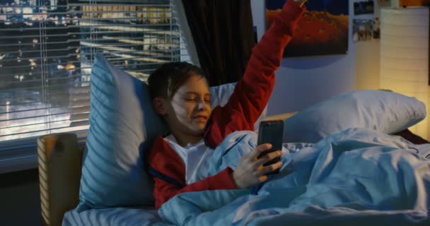 Boy making a video call with his smartphone — Stock Video