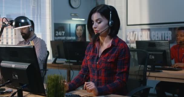 Exhausted woman working at a support center — Stock Video