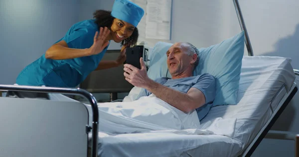 Male patient using video call in hospital room